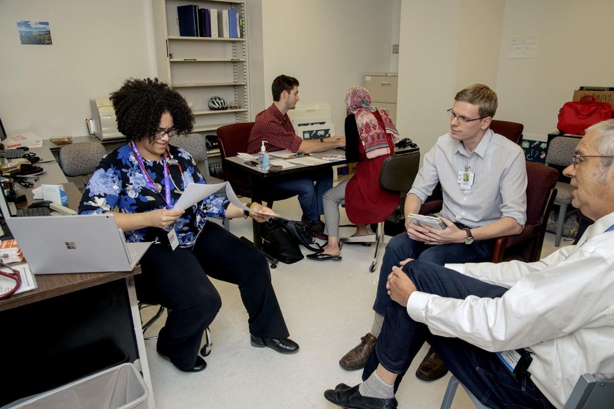 Dr. Ole Thienhaus, chairman of the UA’s department of psychiatry, far right, discusses patient assessments made by medical students Kaylyn Ringgenberg, left, and Daniel Carlson. Ron Medvescek / Arizona Daily Star