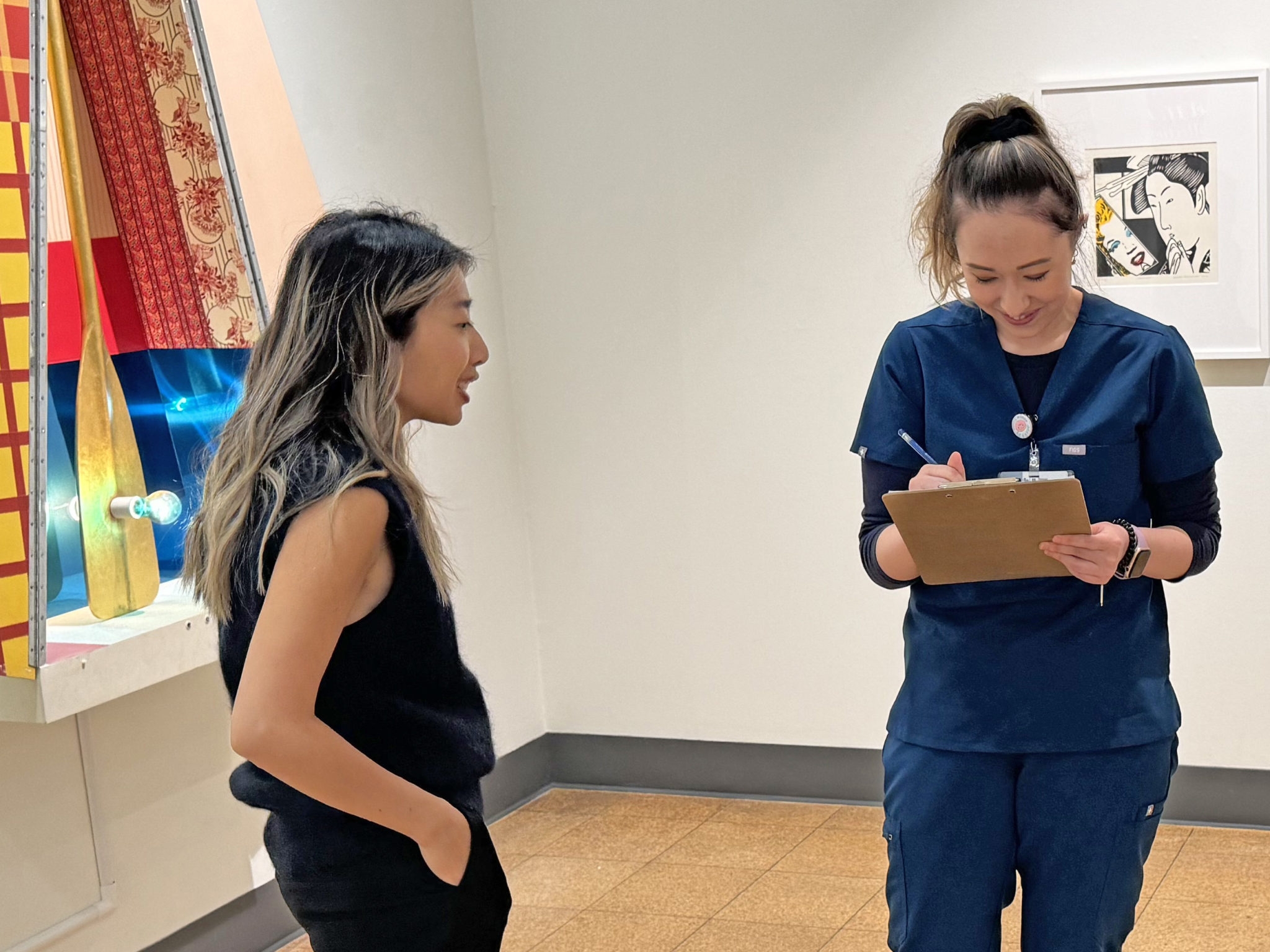 Workshop co-founder Amy Hu (left) gives encouragement during the drawing activity.