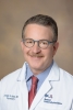 Dr. Jordan Karp in a white coat